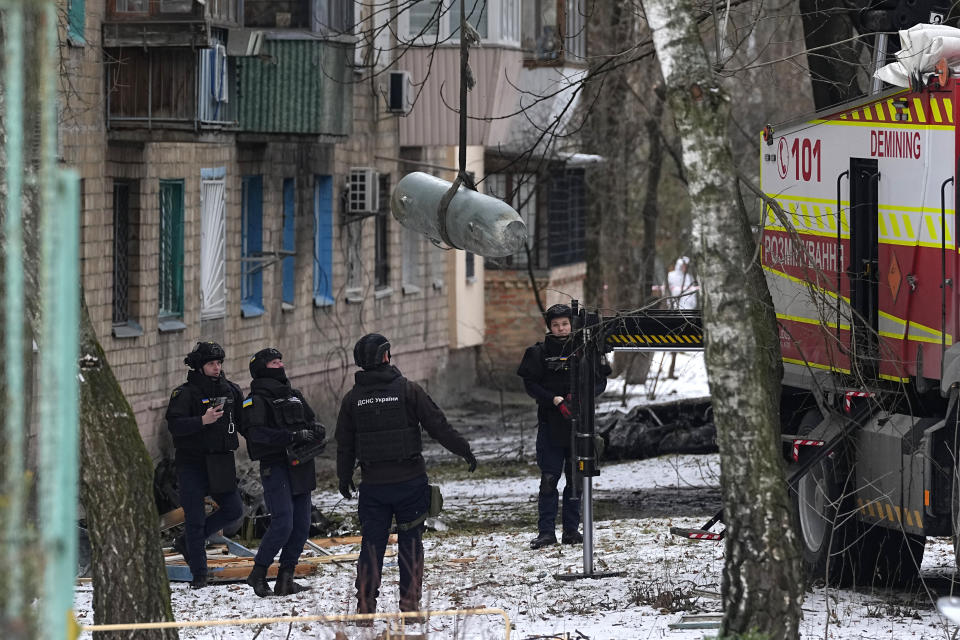 Sappers load an unexploded missile warhead onto a truck at the site of Russian attack in Kyiv, Ukraine, Tuesday, Jan. 23, 2024. (AP Photo/Efrem Lukatsky)