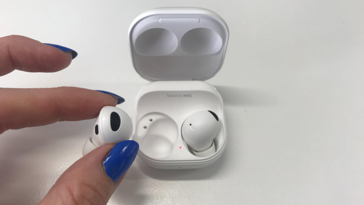  Samsung Galaxy Buds 2 Pro held in a hand on white background. 