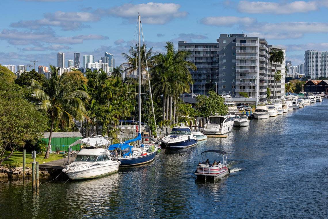 A pontoon boat retrofitted with a Hercules Electric Marine electric motor and battery cruises the Miami River during a private test trial for the Miami International Boat Show in Miami, Florida, on Tuesday, February 14, 2023.