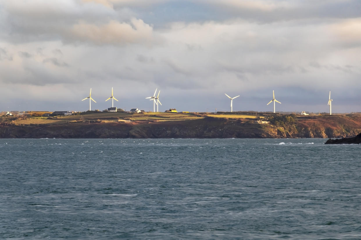 Onshore wind turbines on the French coast village, sustainable wind energy for domestic use in Brittany, France