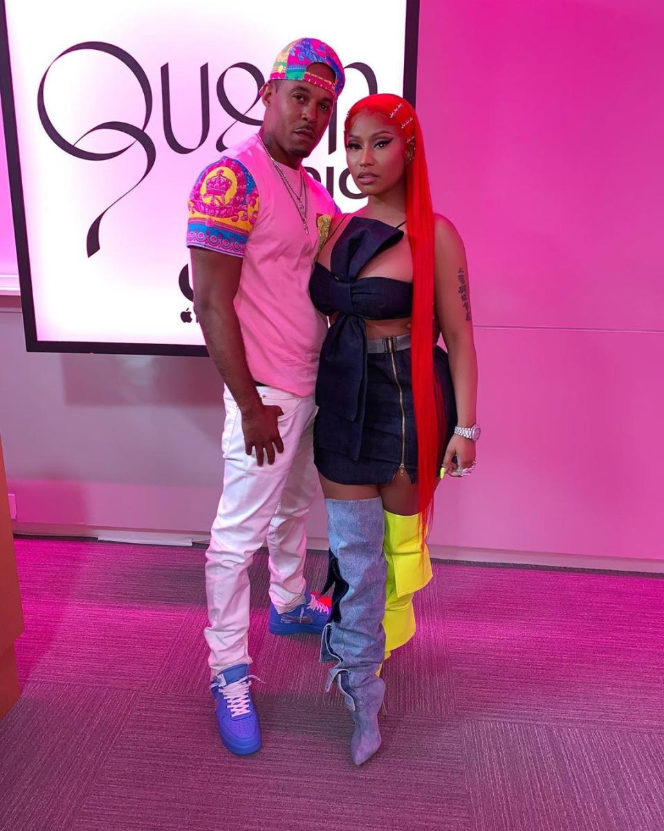 Kenneth Petty Wearing Jeans and a t-Shirt With Nicki Minaj in a Black Dress