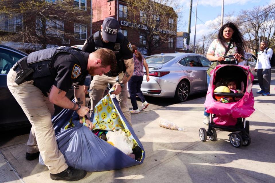 Members of the New York City Police Department conducted a raid and confiscated clothing, fruit, shoes and other items from vendors who were selling items on the sidewalk. James Keivom