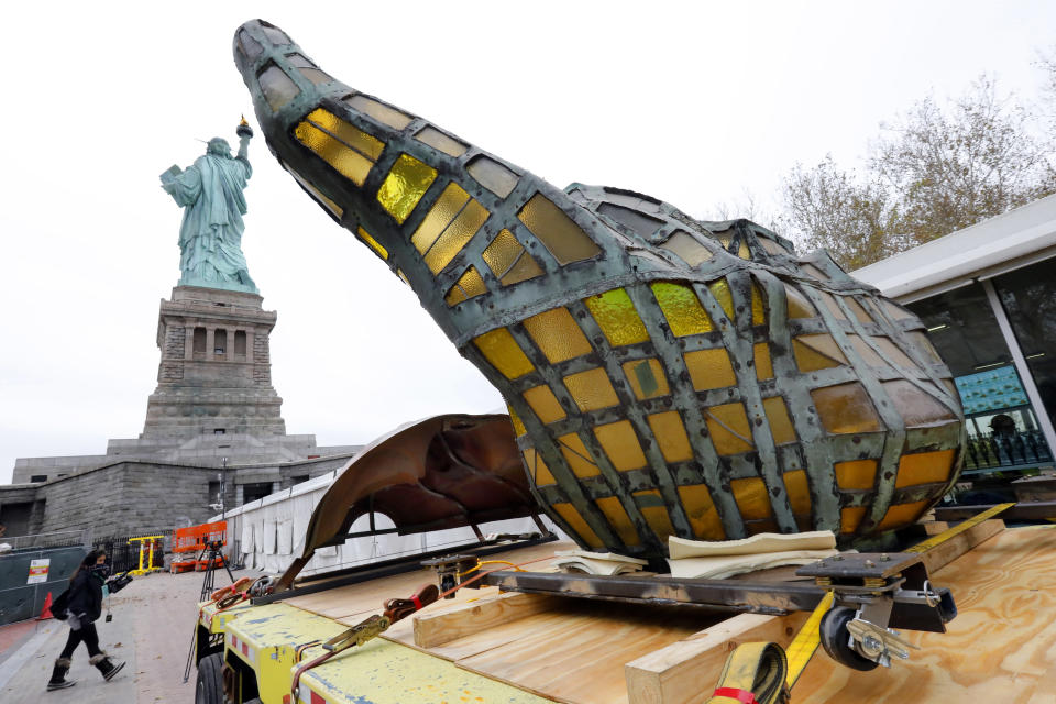 The original torch of the Statue of Liberty rests on a hydraulically stabilized transporter, Thursday, Nov. 15, 2018 in New York. The torch, which was removed in 1984 and replaced by a replica, was being moved into what will become its permanent home at a new museum on Liberty Island. (AP Photo/Richard Drew)