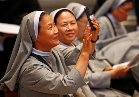 Korean nuns take pictures before the start of a special mass for peace in the Korean peninsula led by Italian cardinal Pietro Parolin in Saint Peter's Basilica at the Vatican, October 17, 2018. REUTERS/Max Rossi