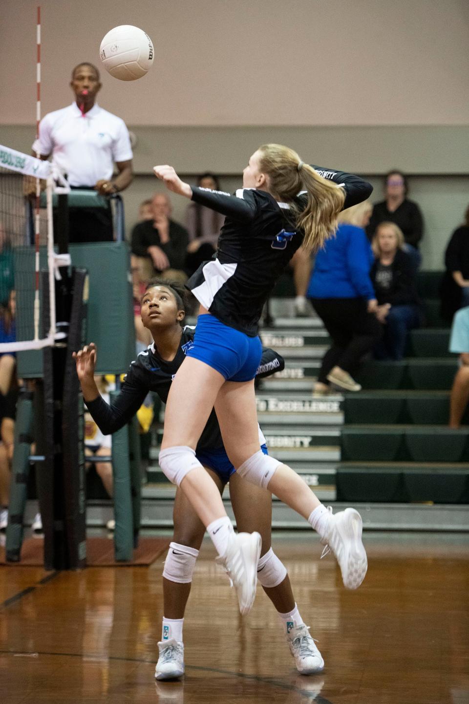 Trinity Christian's Ariel Ross (No. 9) watches as teammate Hadley Dantzler (No. 8) smashes the ball over the net during the 2021 volleyball regionals. The Conquerors play Ocala Trinity Catholic on Tuesday, seeking a trip to the state semifinal.