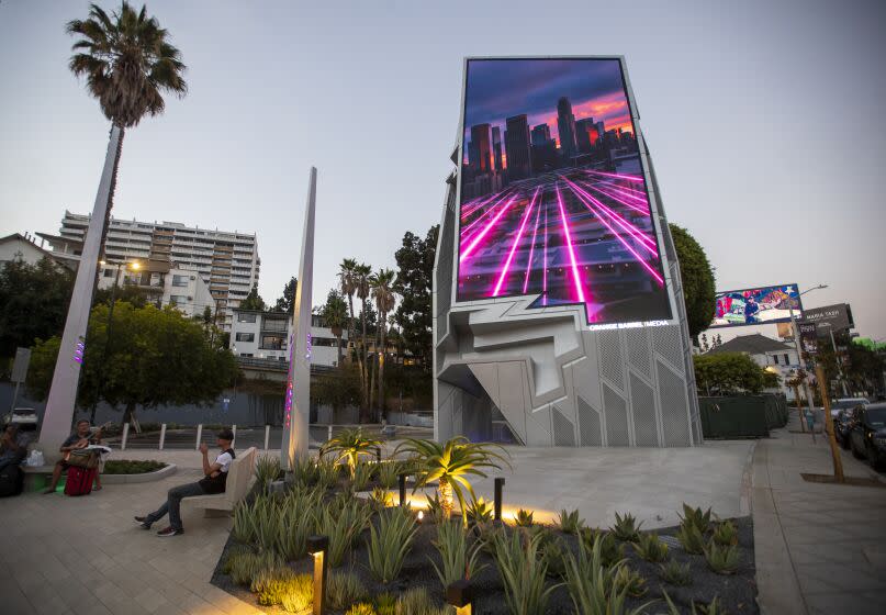 West Hollywood, CA - August 22: A digital billboard, formally known as the Sunset Spectacular, is viewed on the edge of a public parking lot on the Sunset Strip at Sherbourne Drive in West Hollywood Monday, Aug. 22, 2022. It was designed by Tom Wiscombe of Tom Wiscombe Architecture. (Allen J. Schaben / Los Angeles Times)