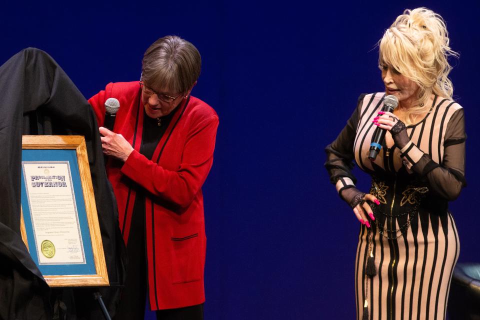 Gov. Laura Kelly presents a proclamation to Dolly Parton marking August 14, 2023, as Imagination Library of Kansas Day during a celebration in Overland Park.