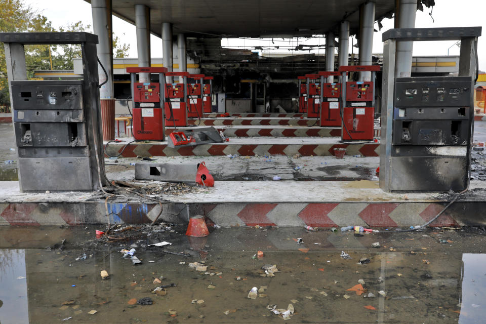 Rainwater pools at a gas station attacked during protests over government-set gasoline prices in Tehran, Iran, Wednesday, Nov. 20, 2019. The demonstrations struck at least 100 cities and towns, spiraling into violence that saw banks, stores and police stations attacked and burned. (AP Photo/Ebrahim Noroozi)