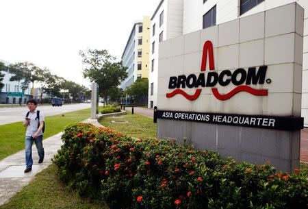 A man passes Broadcom's Asia operations headquarters office at an industrial park in Singapore in this file photo from September 16, 2014. REUTERS/Edgar Su/Files
