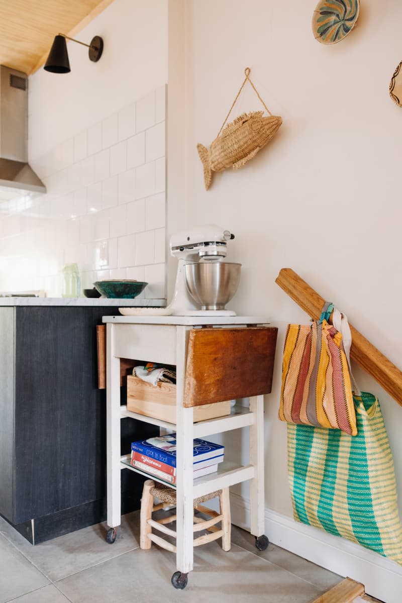 Philadelphia residence with white walls, lots of wood details: corner of kitchen with small shelves, mixer, decorative  objects on wall
