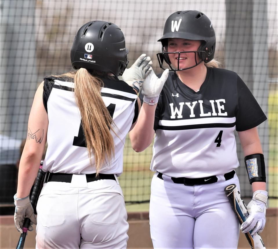 Wylie's Reese Farrar (4) celebrates with Jadyn Fernandez after Fernandez scored on Cameron Gregory's two-out, RBI single in the fourth inning. It capped a four-run inning to snap a 3-3 tie against Cooper.