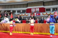 Children present flowers to North Korean leader Kim Jong Un, his wife Ri Sol Ju, China's President Xi Jinping and his wife Peng Liyuan during Xi's visit in Pyongyang, North Korea in this undated KCNA photo