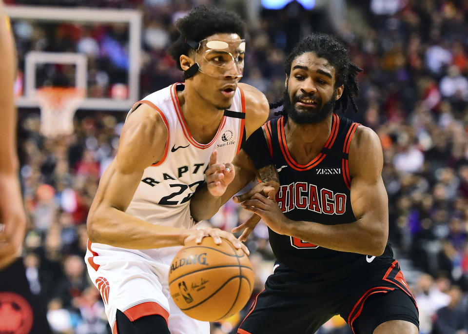 Toronto Raptors forward Patrick McCaw (22) moves the ball past Chicago Bulls guard Coby White (0) during first-half NBA basketball game action in Toronto, Sunday, Feb. 2, 2020. (Frank Gunn/The Canadian Press via AP)