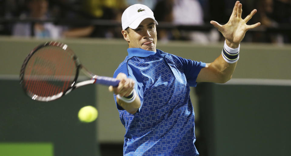 John Isner, of the United States, returns the ball to Nicolas Almagro, of Spain, during the Sony Open Tennis in Key Biscayne, Fla., Monday, March 24, 2014. (AP Photo/J Pat Carter)
