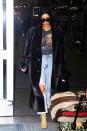 <p>In a fur coat, Sade graphic tee, distressed jeans, Yeezy heels, oversized sunglasses, and a Birkin bag while arriving at JFK airport.</p>