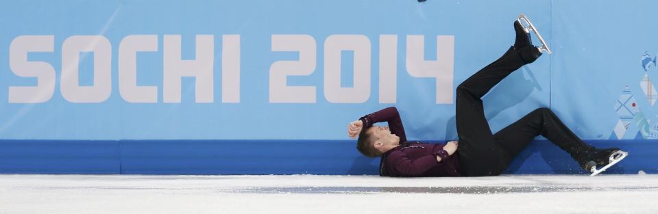 Jeremy Abbott of the U.S. lies on the ice after a fall during the Figure Skating Men's Short Program at the Sochi 2014 Winter Olympics