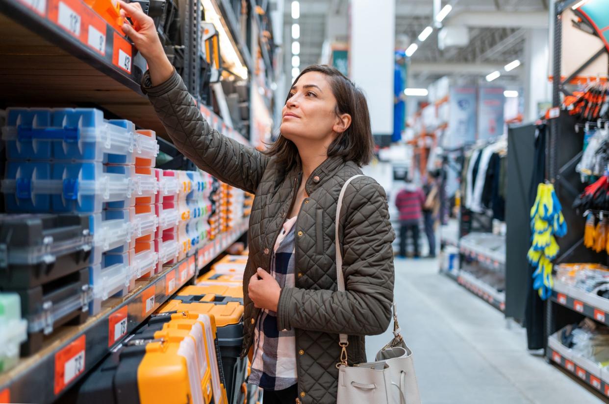 Woman Choosing Materials in Construction Store