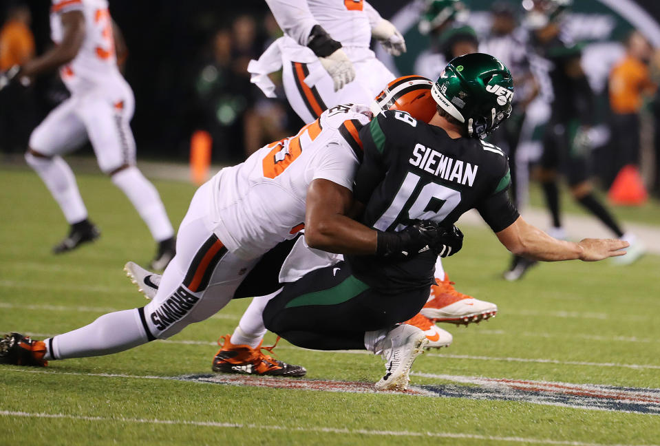 Trevor Siemian of the New York Jets was hurt on this play after he was tackled by Myles Garrett. (Getty Images)