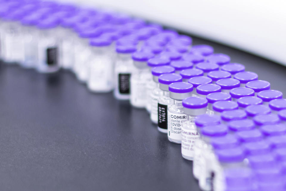 In this March 2021 photo provided by Pfizer, vials of the Pfizer-BioNTech COVID-19 vaccine are prepared for packaging at the company's facility in Puurs, Belgium. On Wednesday, Aug. 25, 2021, the company said it started the application process for U.S. approval of a booster dose of its two-shot COVID-19 vaccine for people ages 16 and older. (Pfizer via AP)