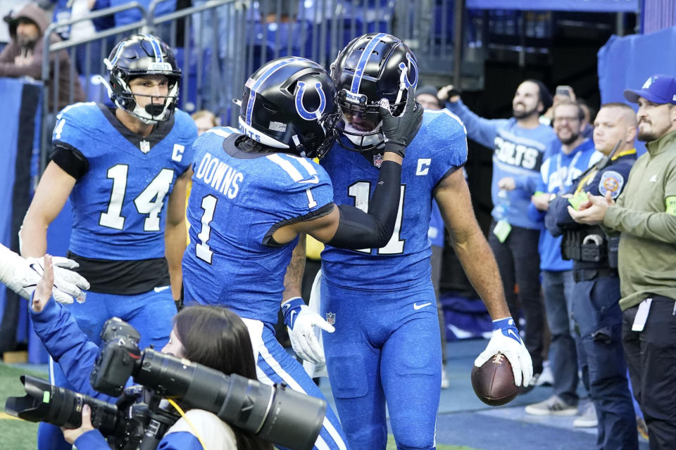 Indianapolis Colts wide receiver Michael Pittman Jr. (11) celebrates with teammate wide receiver Josh Downs (1) after catching a 75-yard touchdown pass during the second half of an NFL football game against the Cleveland Browns, Sunday, Oct. 22, 2023, in Indianapolis. (AP Photo/Michael Conroy)