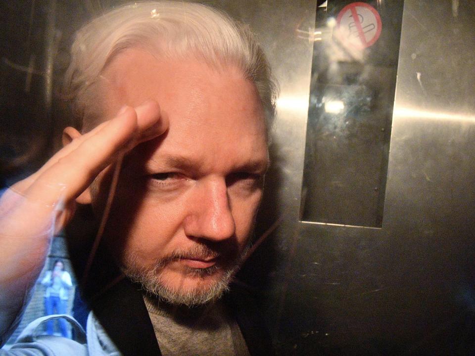 Assange, pictured in 2019 from the window of a prison vanAFP via Getty Images