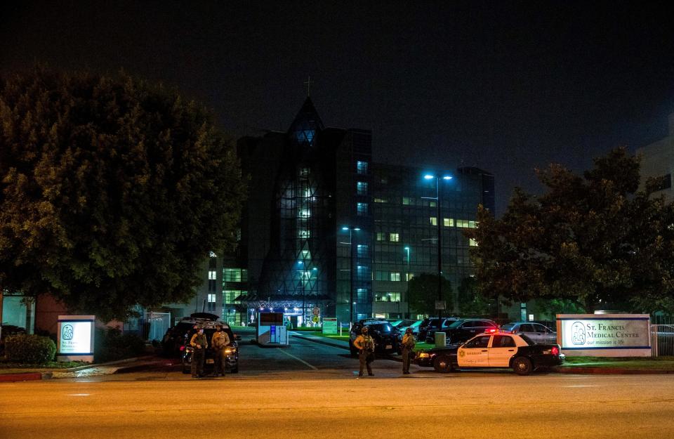 Los Angeles County Sheriff's deputies guard the entrance to St. Francis Medical Center early Monday, Sept. 13, 2020, after two deputies were shot late Saturday, Sept. 12, while sitting inside their patrol vehicle guarding a Metro station in Compton, Calif. (AP Photo/Jintak Han)