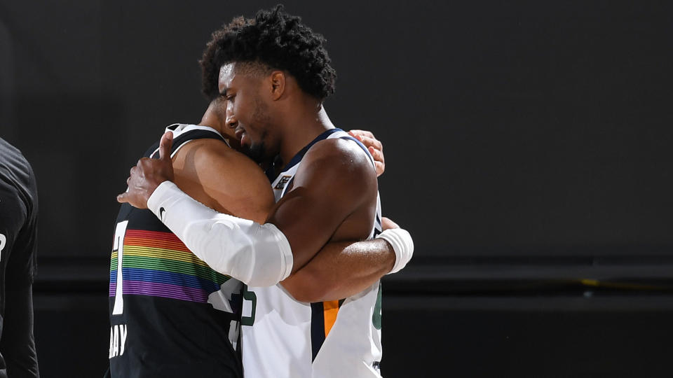 ORLANDO, FL - SEPTEMBER 1: Jamal Murray #27 of the Denver Nuggets hugs Donovan Mitchell #45 of the Utah Jazz after Round One, Game Seven of the NBA Playoffs on September 1, 2020 at AdventHealth Arena in Orlando, Florida. NOTE TO USER: User expressly acknowledges and agrees that, by downloading and/or using this Photograph, user is consenting to the terms and conditions of the Getty Images License Agreement. Mandatory Copyright Notice: Copyright 2020 NBAE (Photo by Andrew D. Bernstein/NBAE via Getty Images)