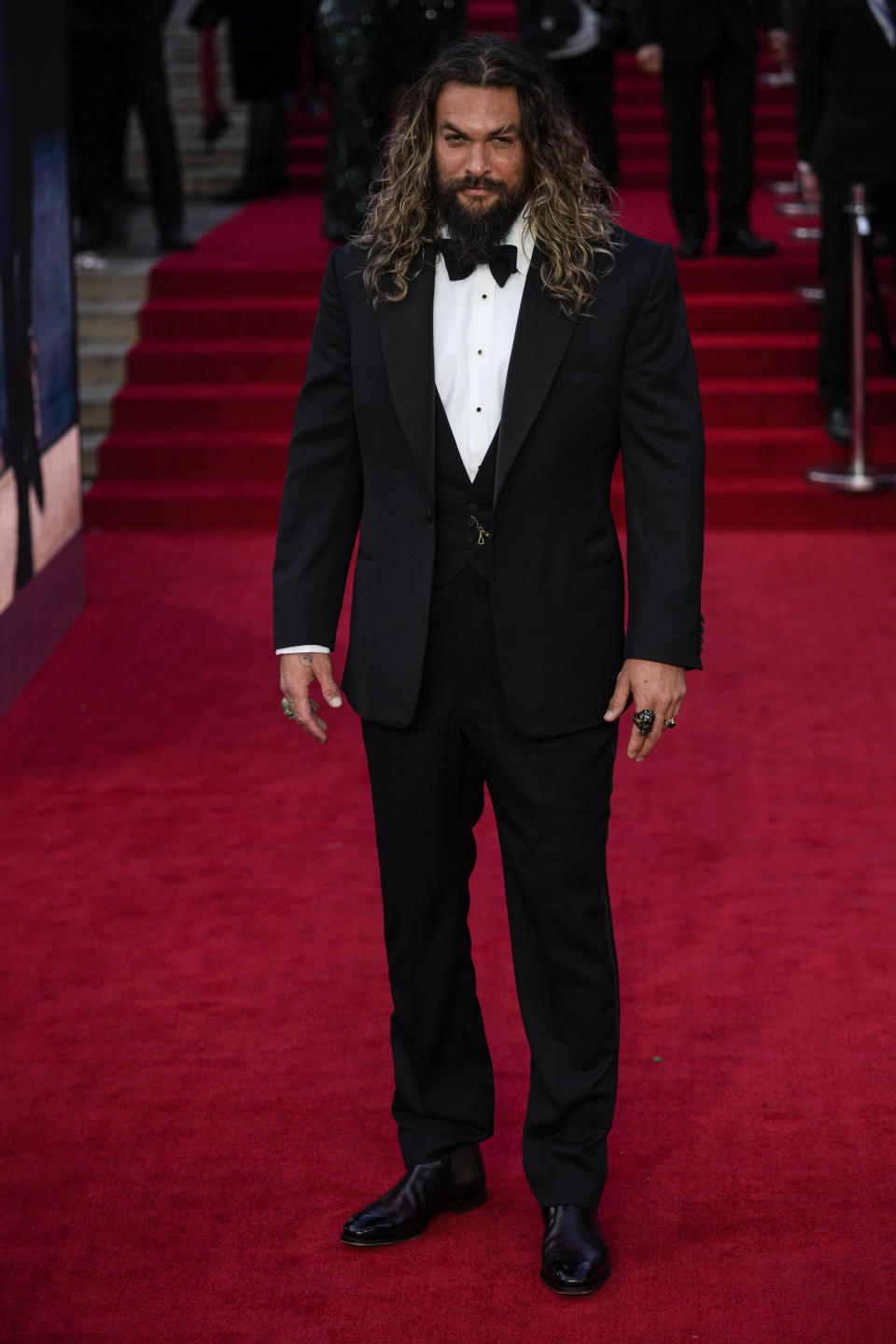 Jason Momoa poses for photographers upon arrival for the world premiere of the new film from the James Bond franchise "No Time To Die" in London, Tuesday, Sept. 28, 2021. (AP Photo/Matt Dunham)