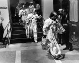 FILE - In this Dec. 21, 1968 file photo, Apollo 8 astronauts, suited up and ready to go, walk to a van heading for their Saturn V rocket for their moon orbit mission from Cape Kennedy, Fla. Leading the way is Commander Frank Borman, followed by James A. Lovell and William A. Anders. (AP Photo)