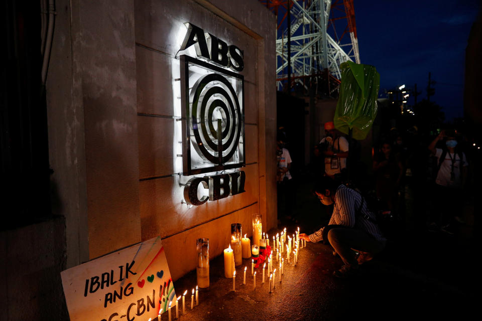 FILE PHOTO: A journalist lights a candle outside the ABS-CBN headquarters, following Philippine congress&#39; vote against the broadcast network&#39;s franchise renewal, in Quezon City, Metro Manila, Philippines, July 10, 2020. (Source: REUTERS/Eloisa Lopez)