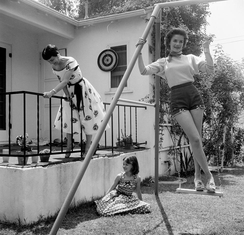 <p>Wood, seen here at her Los Angeles home with her mother, Maria Zakharenko, and younger sister, had a <a href="https://www.cnn.com/2011/11/19/showbiz/celebrity-news-gossip/natalie-wood-life/index.html" rel="nofollow noopener" target="_blank" data-ylk="slk:complicated relationship;elm:context_link;itc:0;sec:content-canvas" class="link ">complicated relationship</a> with her mother, who managed her career. An aspiring performer herself, Maria reportedly <a href="https://www.newsweek.com/real-tragedy-natalie-wood-65945?utm_medium=google" rel="nofollow noopener" target="_blank" data-ylk="slk:pushed her daughters;elm:context_link;itc:0;sec:content-canvas" class="link ">pushed her daughters</a> into the industry and was <a href="https://variety.com/2001/more/reviews/natasha-the-biography-of-natalie-wood-1200469640/" rel="nofollow noopener" target="_blank" data-ylk="slk:extremely controlling over their careers;elm:context_link;itc:0;sec:content-canvas" class="link ">extremely controlling over their careers</a>. </p>