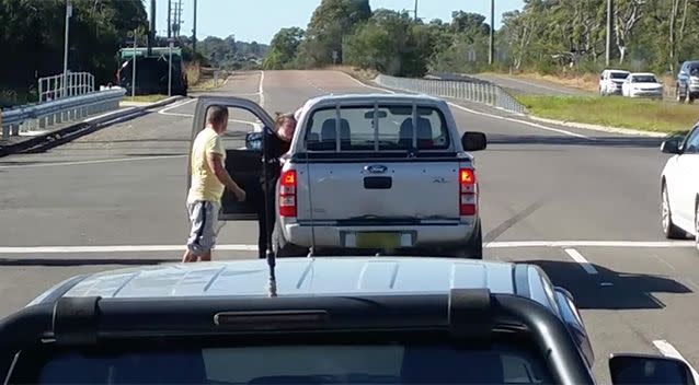 The shocked woman can be seen leaning against her car, clutching at her face. Source: Facebook