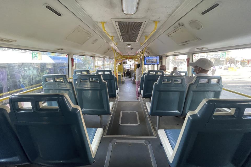 Few commuters ride on a mostly empty bus in Yangon, Myanmar on Tuesday, Feb. 1, 2022. Opponents of military rule in Myanmar on Tuesday marked the one-year anniversary of the army's seizure of power with a nationwide strike to show their strength and solidarity amid concern about what has become an increasingly violent contention for power. (AP Photo)