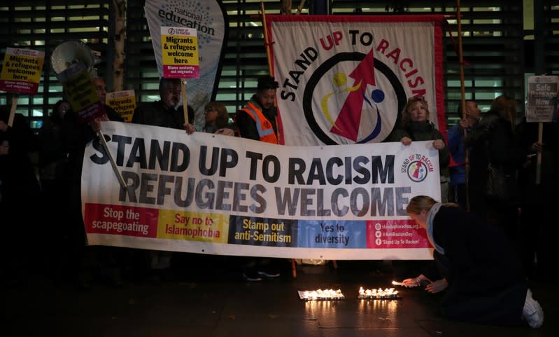 Anti-racism campaigners take part in a vigil, following the discovery of 39 bodies in a truck container, outside the Home Office in London