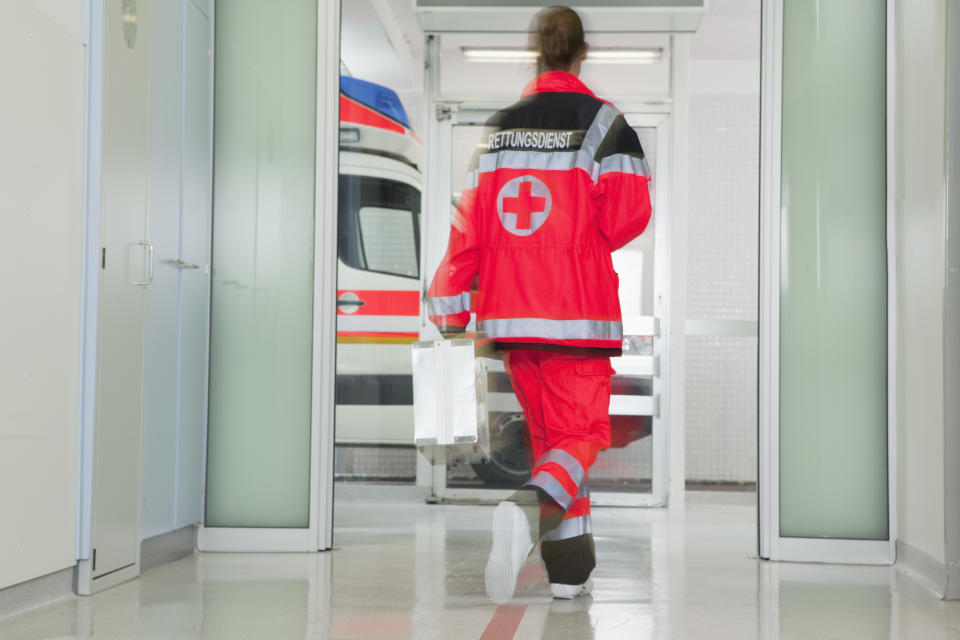 Back of paramedic rushing at hall