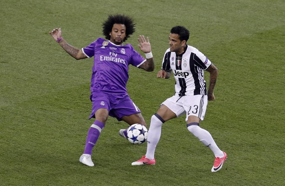 <p>Real Madrid’s Marcelo in action with Juventus’ Dani Alves </p>
