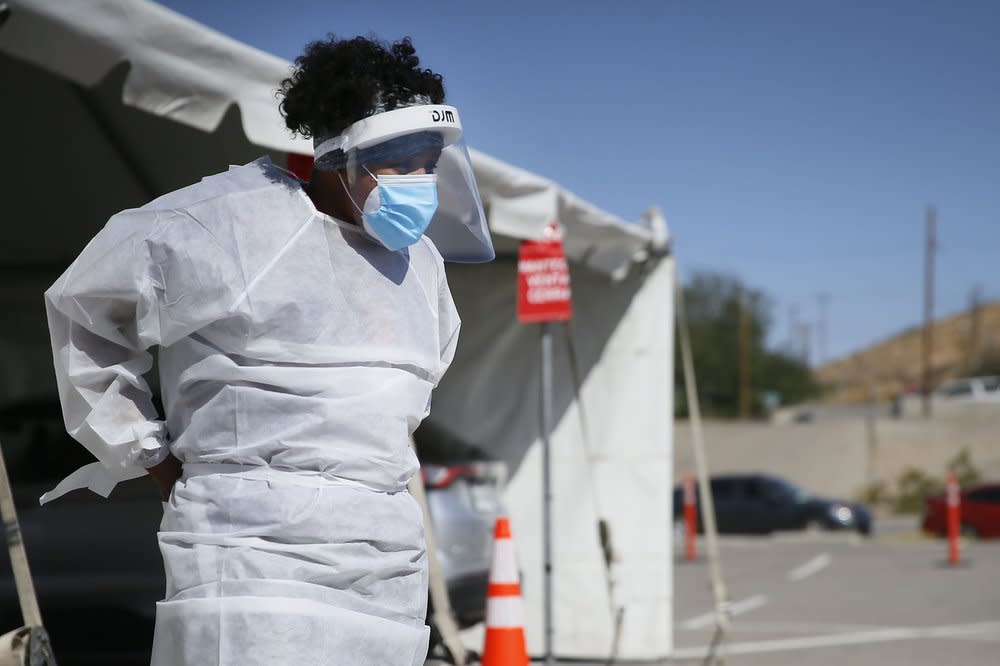 In this Oct. 26,2020, file photo, a medical worker stands at a COVID-19 state drive-thru testing site at UTEP, in El Paso, Texas. (Briana Sanchez/The El Paso Times via AP, File)