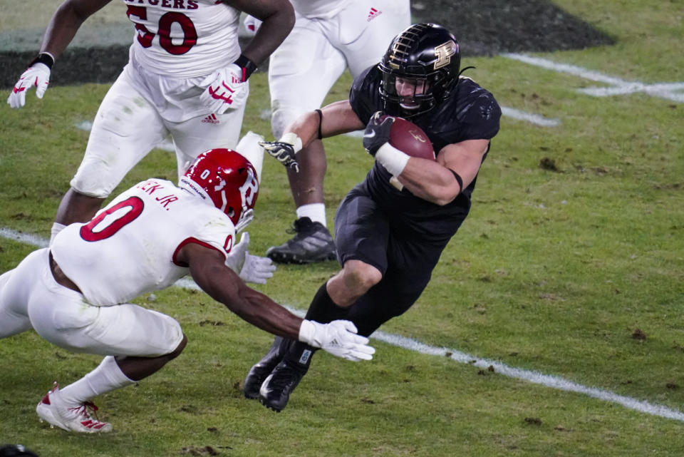 Purdue running back Zander Horvath (40) cuts away from Rutgers defensive back Christian Izien (0) during the second quarter of an NCAA college football game in West Lafayette, Ind., Saturday, Nov. 28, 2020. (AP Photo/Michael Conroy)