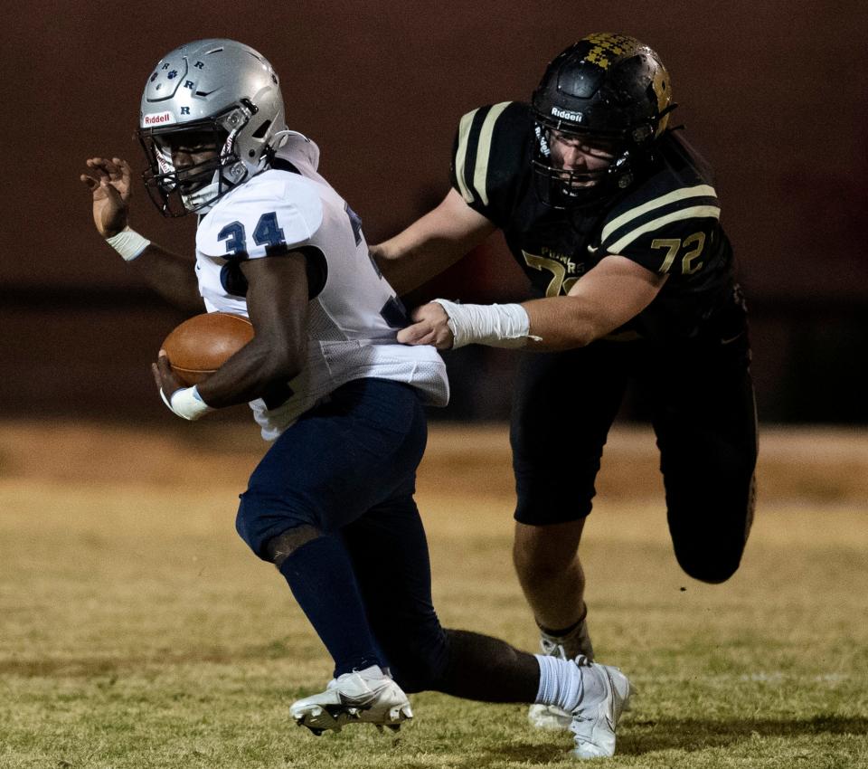 Boonville’s Stihl Scott (72) brings down Reitz's Jonas Burnett (34) during their IHSAA sectional semifinal at Bennett Field in Boonville, Ind., Friday night, Oct. 28, 2022.