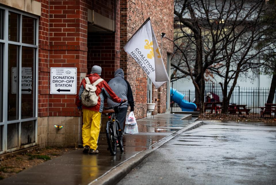 The White Flag flies at Wayside Christian Mission in downtown Louisville on Thursday evening before dangerous temperatures grip the region from an impending winter storm. Dec. 22, 2022