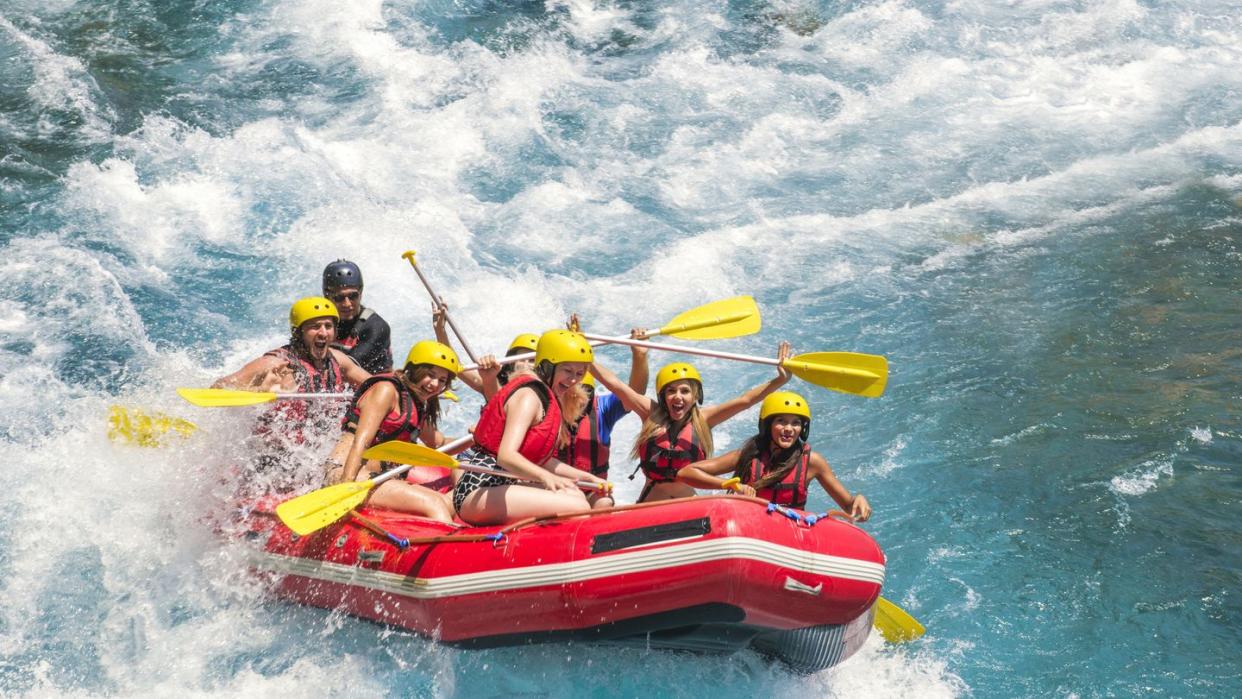group of people white water rafting