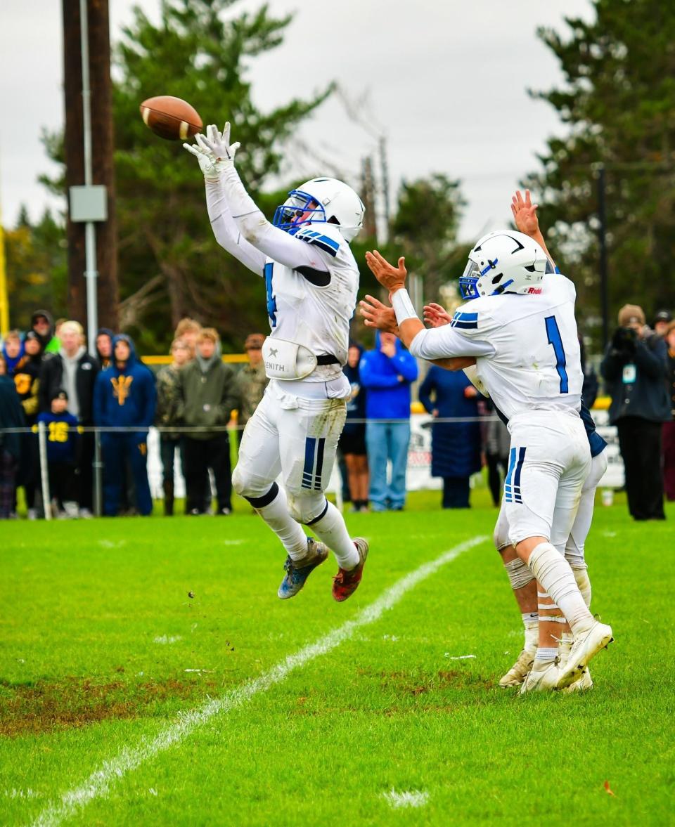 Inland Lakes senior defensive back Jake Willey (left) intercepts a pass during the closing stages at Gaylord St. Mary last week. The Bulldogs host Alcona in the first round of the playoffs this Friday at 7 p.m.