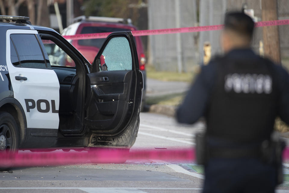 Police investigate the scene where three Houston Police Department officers were shot near the intersection of McGowen and Hutchins Thursday, Jan. 27, 2022, in Houston. Authorities say a police chase in Houston ended with a shootout that wounded the officers. The incident happened about 2:40 p.m. Thursday when a car that police were pursuing crashed at an intersection just off Interstate 69 on the southeastern edge of downtown Houston. (Brett Coomer/Houston Chronicle via AP)