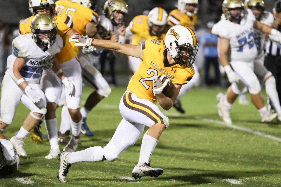 Golden West's Case Anders rushes against Monache in an East Yosemite League high school football game at Visalia Community Stadium in Visalia, Calif., Friday, Sept. 30, 2022.