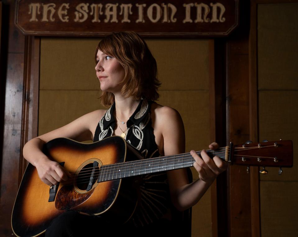 Bluegrass singer-songwriter Molly Tuttle, poses for a portrait at Station Inn Monday, March 21, 2022 in Nashville, Tenn. Tuttle will celebrate the release of her  new album "Crooked Tree" at the venue in late March.