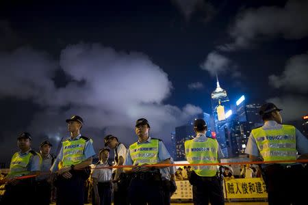 Police officers stand guard during a demonstration outside the Legislative Council building in Hong Kong, China June 17, 2015. REUTERS/Tyrone Siu