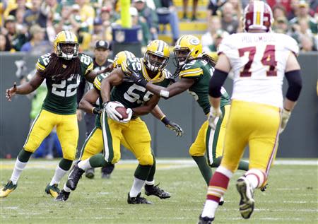 Green Bay Packers linebacker Brad Jones (C) gets a fumble recovery during the second half of their NFL football game against the Washington Redskins in Green Bay, Wisconsin September 15, 2013. The Packers defeated the Redskins 38-20. REUTERS/Darren Hauck