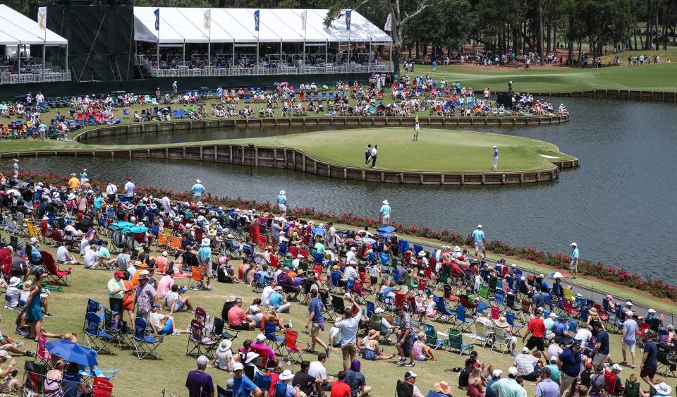 Fans pack seating areas around No. 17, the famous Island Green, at the Stadium Course at TPC Sawgrass during the 2018 The Players Championship golf tournament.