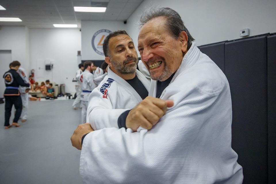 Donald Weiss, right, practices with Bijan Parsa, center during his weekly workout at Gracie Elite Jiu-Jitsu in Wellington, Fla., on June 23, 2023.