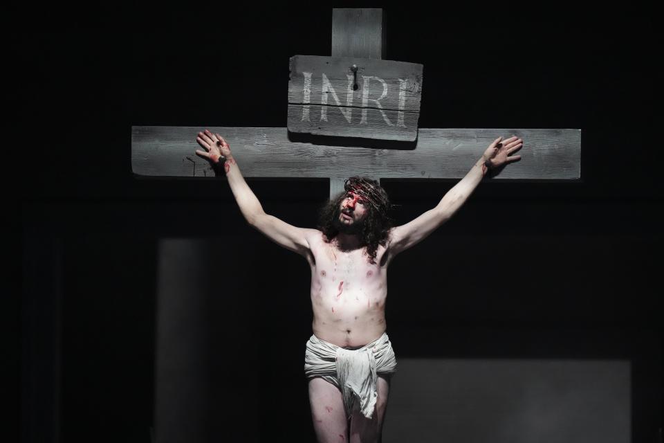 Rochus Rueckel as Jesus performs during the rehearsal of the 42nd Passion Play in Oberammergau, Germany, Wednesday, May 4, 2022. After a two-year delay due to the coronavirus, Germany's famous Oberammergau Passion Play is opening soon. The play dates back to 1634, when Catholic residents of a small Bavarian village vowed to perform a play of the last days of Jesus Christ every 10 years, if only God would spare them of any further Black Death victims. The town did suffer some COVID-19 deaths, but the show goes on. Almost half of the village's residents— more than 1,800 people including 400 children — will participate. (AP Photo/Matthias Schrader)